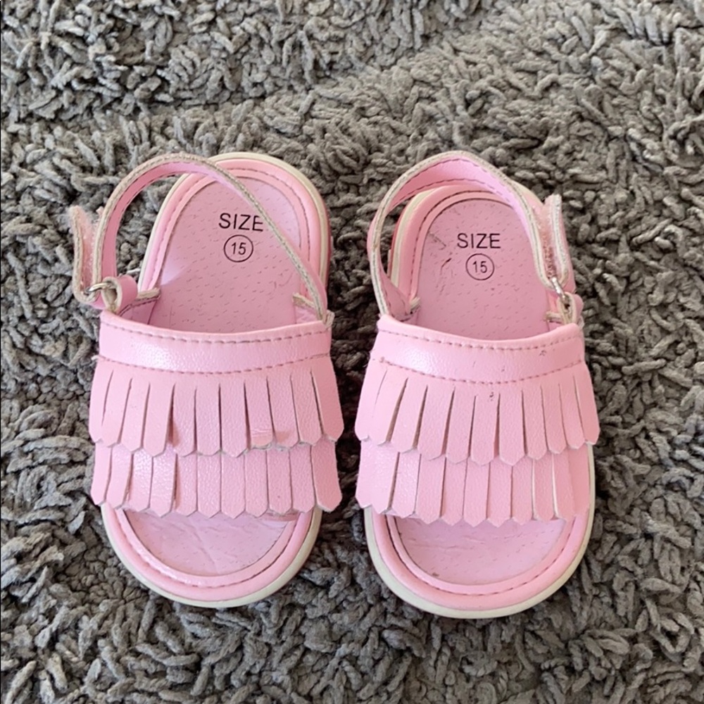 Toddler sandals with squeakers in the heel.